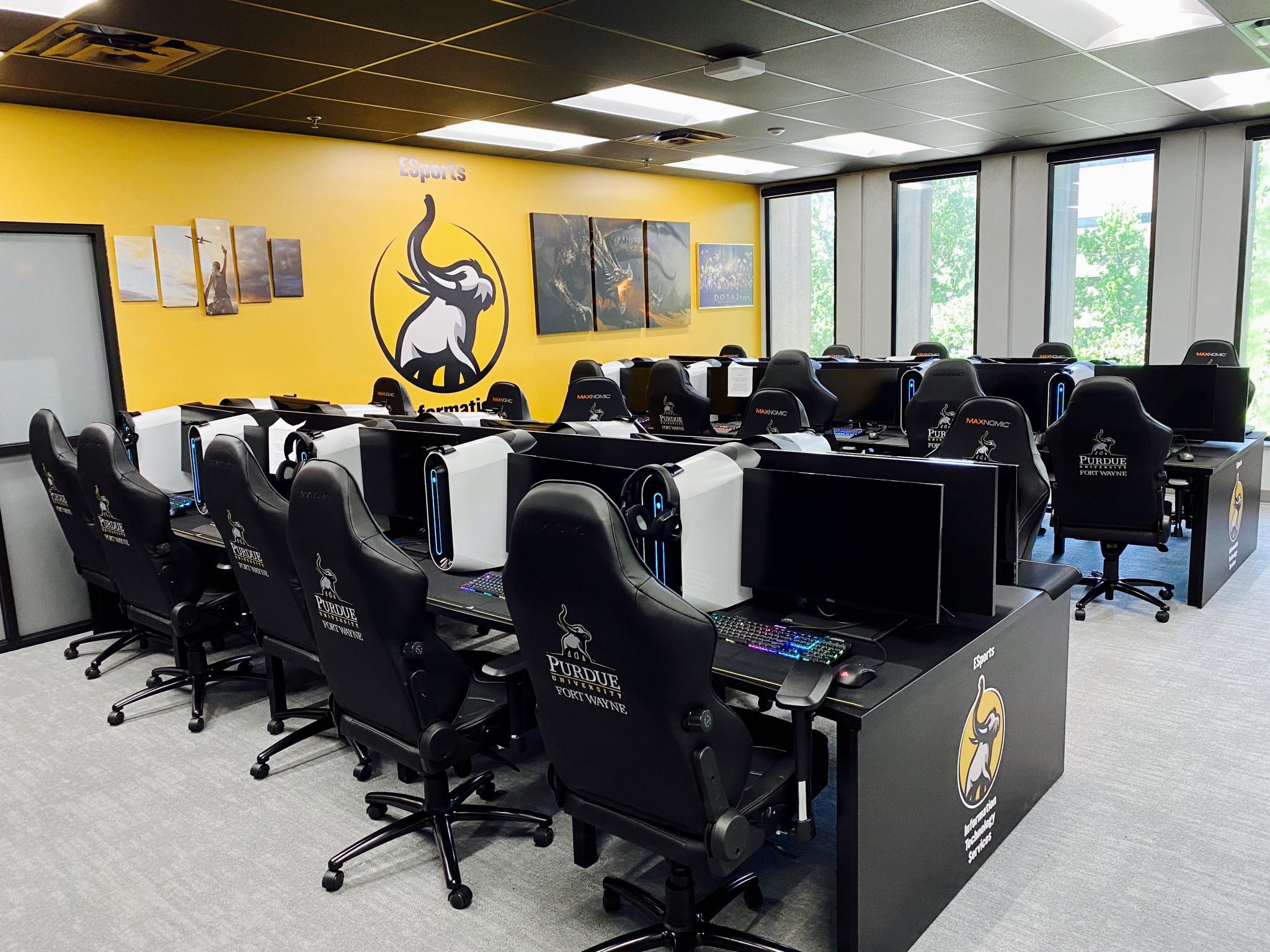 photo of room filled with chair and tables with computers