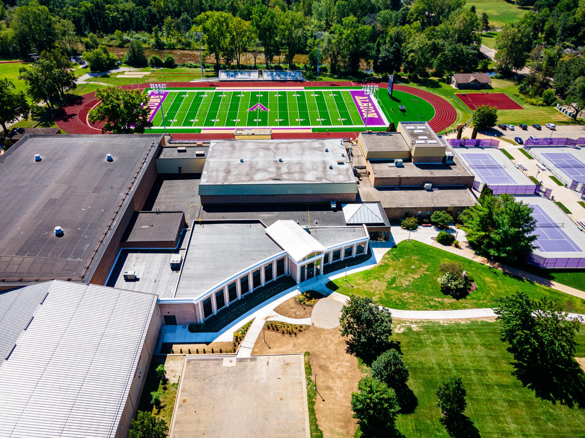 aerial image of building with athletics field nearby