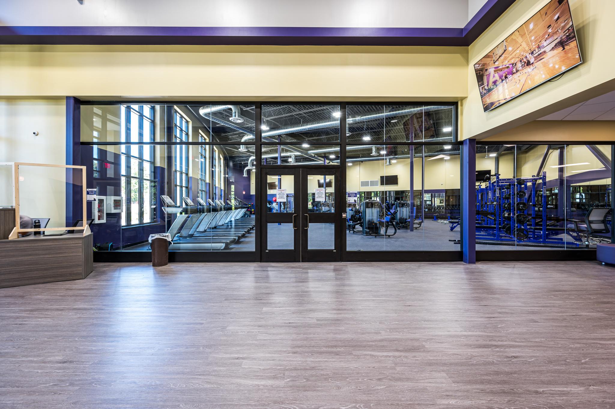 image of pair of glass doors into a room with fitness equipment