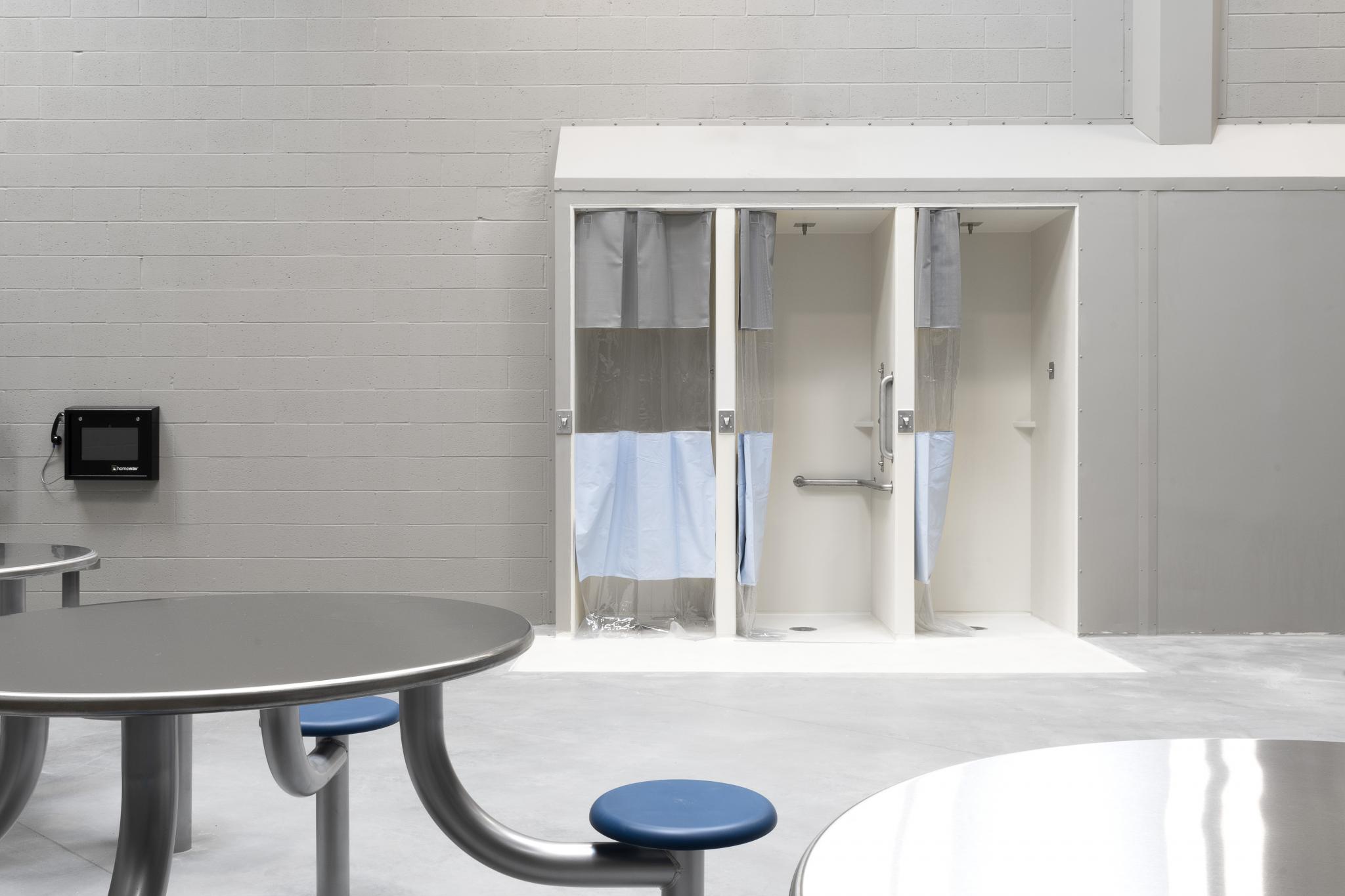 image of a table with chairs and shower stalls
